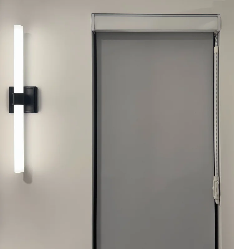 Grey roller shade beside a black vanity light